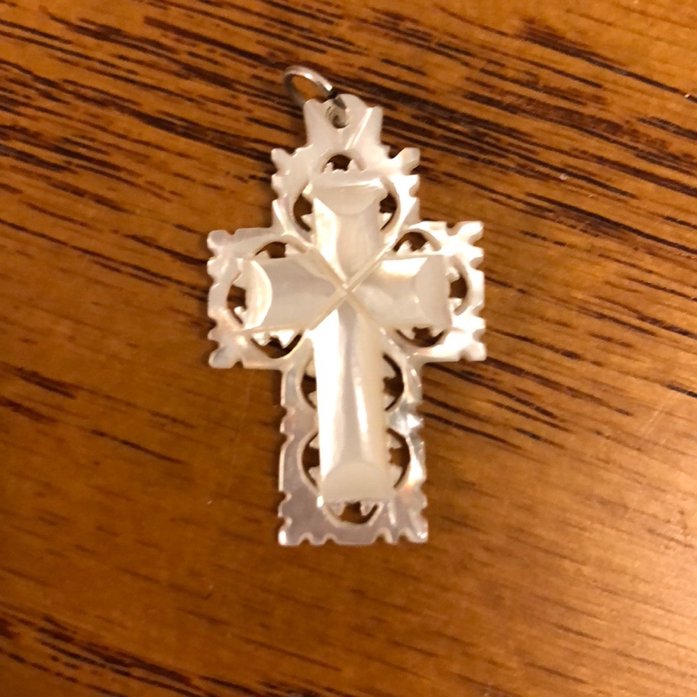 Opal colored cross pendant.